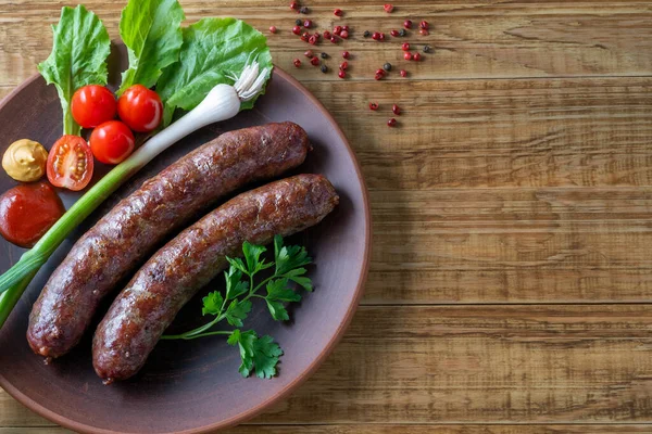 Food poster, restaurant setting - a portion of grilled sausages with tomatoes and herbs, ketchup, mustard. On a rustic table.