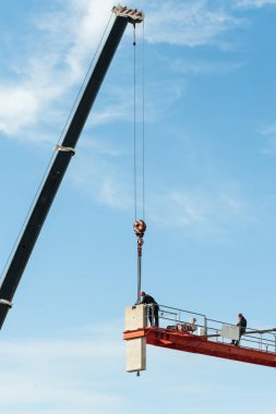 Tanınmayan teknisyenleri bir inşaat vinç derlemede yer.
