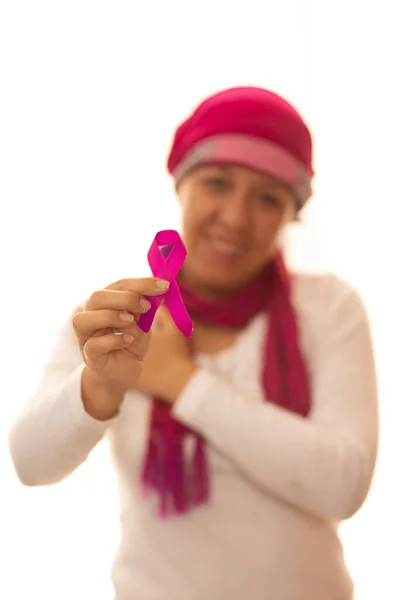 Beyaz arka planda göğüs kanserinin sembolü olarak, İspanyol bir kadın pembe kurdeleyi eliyle kaldırıyor.