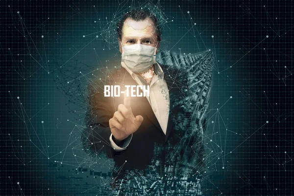 Middle-aged man in the shape of a robot and using mouth covers, touching a screen with a bio tech sign on his fingers. Robotic Technology and DNA Concept