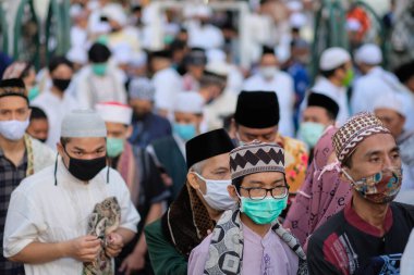 Malang, Doğu Cava / Endonezya - 24 Mayıs 2020: Kurban namazından sonra yüz maskesi takan Müslüman bir kalabalık camiyi terk etti