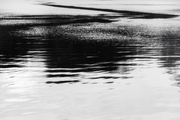 black and white lake water surface with ripple