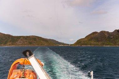 Motorlu tekne, göl suyu ve dağlardan manzara 