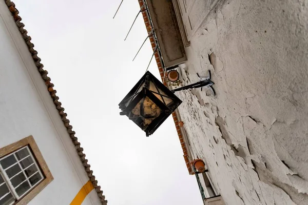 Lisbon, Portugal: The beautiful little village of Obidos in the central Portugal during the national medieval day. Wooden art craft of Mercado (in english: Market) in the heart of the village