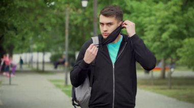 Dünya çapında salgın sırasında Corona virüsünün önlenmesi için cerrahi maske takan adam.