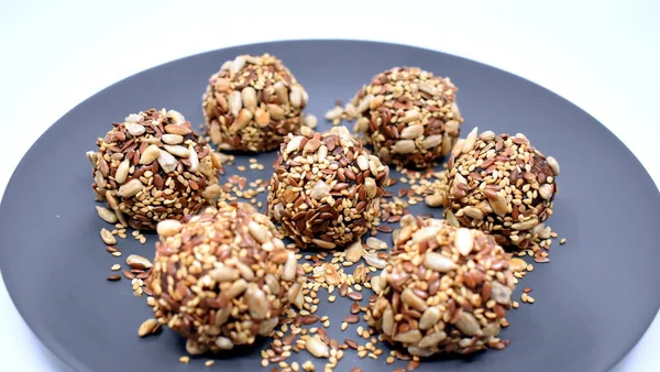 Vegan sweets made from dried fruits and sesame seeds, flax and sunflower seeds