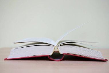 Okul masasında açık bir kitap var.