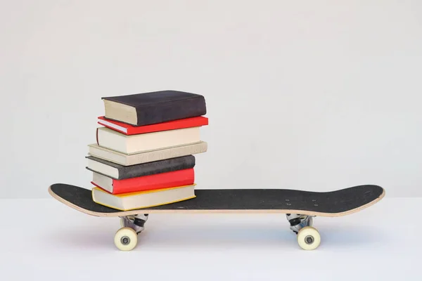 School books on a skateboard