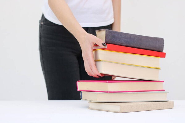  A beautiful young student holds books in her hands
