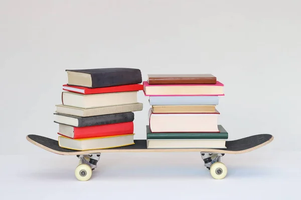 School books on a skateboard