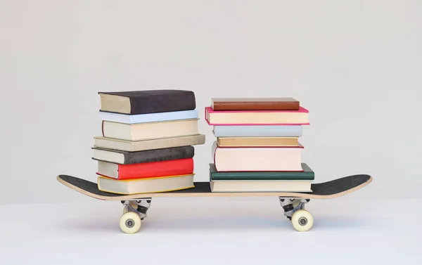 School books on a skateboard