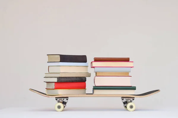 School books on a skateboard