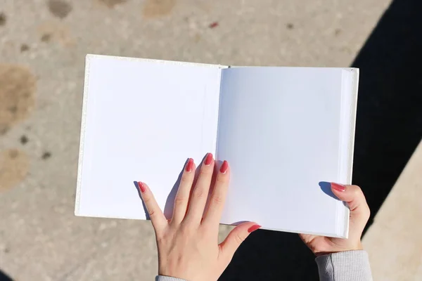 White book in hand