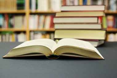 Kütüphanede siyah bir arkaplan üzerine açık bir kitap