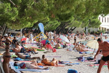 Hırvatistan 'ın Makarska kenti, 28.08.2020. Coronavirüs salgını sırasında, pek çok Avrupalı turist tatillerini geçirdikleri Dalmaçya' daki küçük kasabalarda Hırvat plajlarında dinleniyor.
