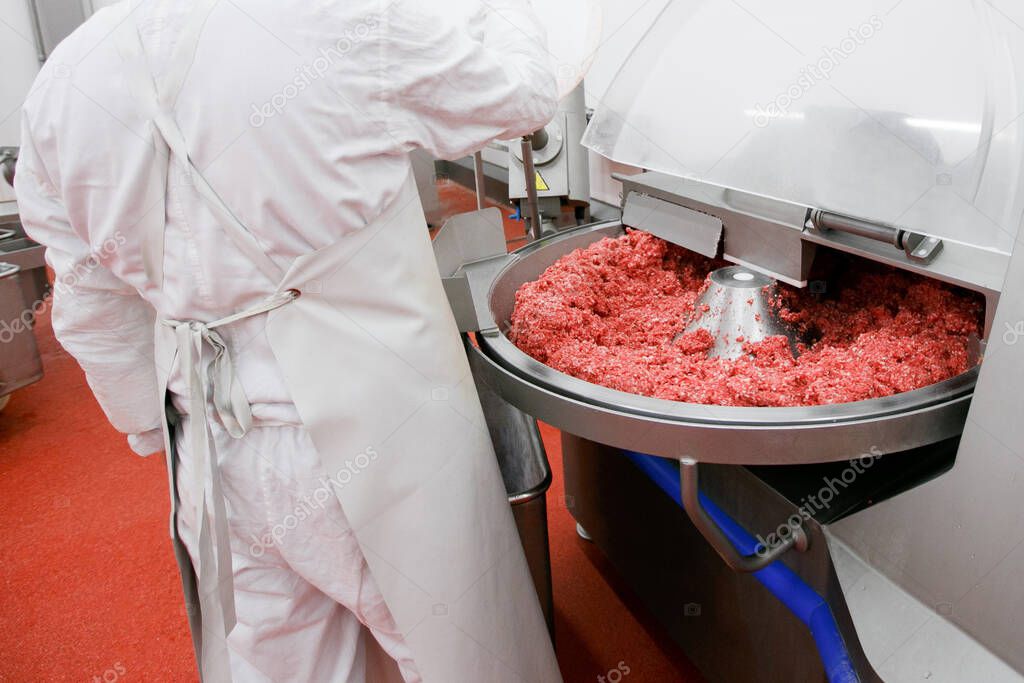 Process for the production of products of animal origin. Raw meat minced in an industrial process factory stored in a stainless steel crate at a processing.