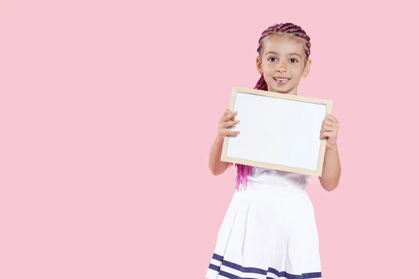 Mooi Kleuterschoolmeisje Met Een Klein Schoolbord Roze Achtergrond Poserend Studio — Stockfoto