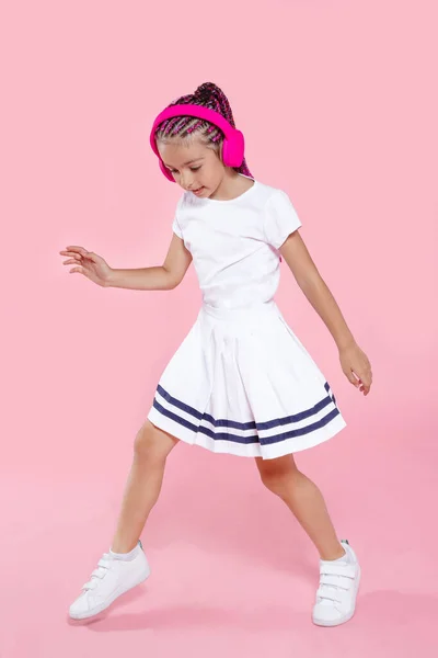 Ganska Förskolebarn Dansar Med Hörlurar Över Rosa Bakgrund Glad Liten — Stockfoto