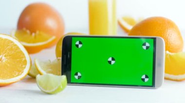  Yeşil Kroma Anahtar Ekranlı Akıllı Telefon Görüntüsü Turuncu, Limon ve Limon dolu Masa
