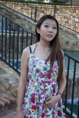 Güzel Asyalı kadın dışarıda düşünceli görünüyor.