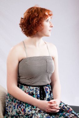 Dalgın kızıl saçlı kadın güzel görünüyor.