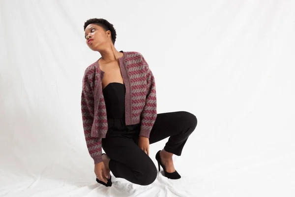 Pretty Black woman squatting