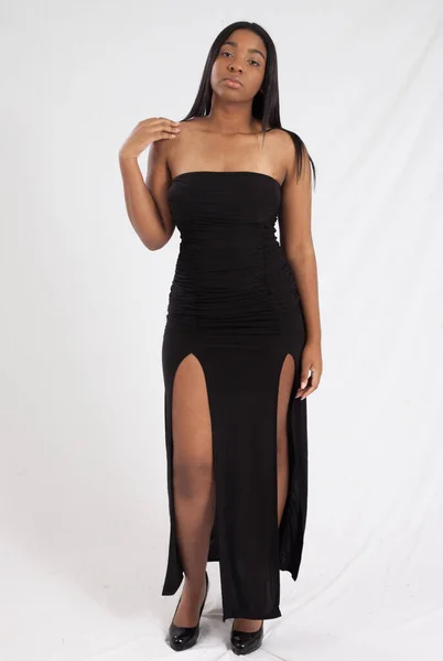 Pensive Black woman in a black dress