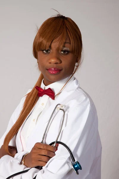 Thoughtful woman in a lab coat with a stethoscope