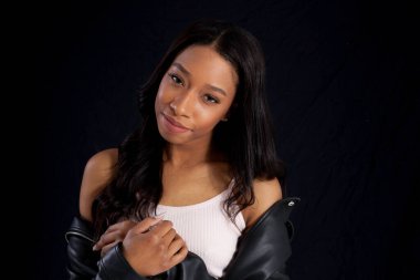 Siyah deri ceketli, gülümseyen güzel bir kadın.