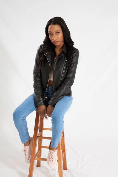 Pretty Black Woman Leather Jacket Jeans Sitting Wooden Stool — Stock Photo, Image