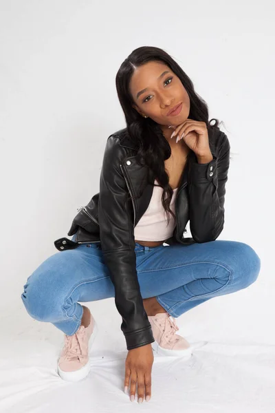 Pensive Black Woman Squatting Blue Jeans — Stock Photo, Image