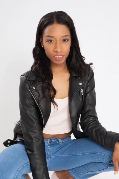 Pensive Black Woman Squatting Blue Jeans — Stock Photo, Image