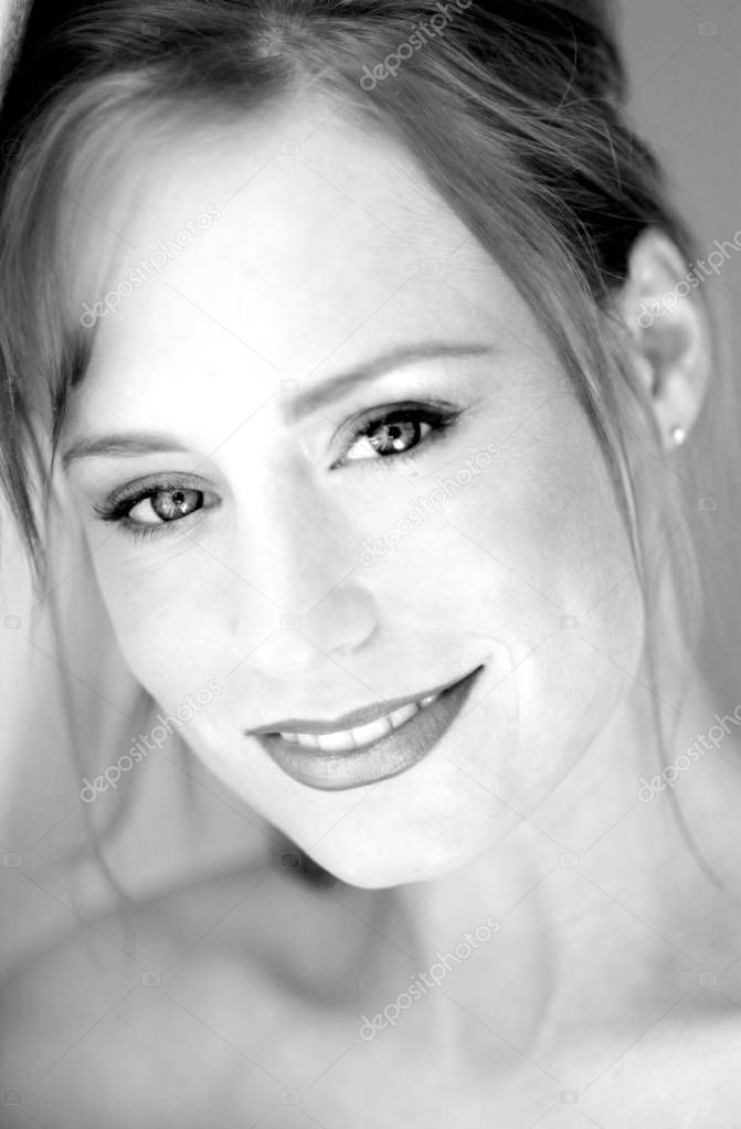 Black and White of Beautiful young woman with stunning eyes looking directly at camera with soft expression - straight hair - black eyeliner and pink lipstick and subdued light lip gloss