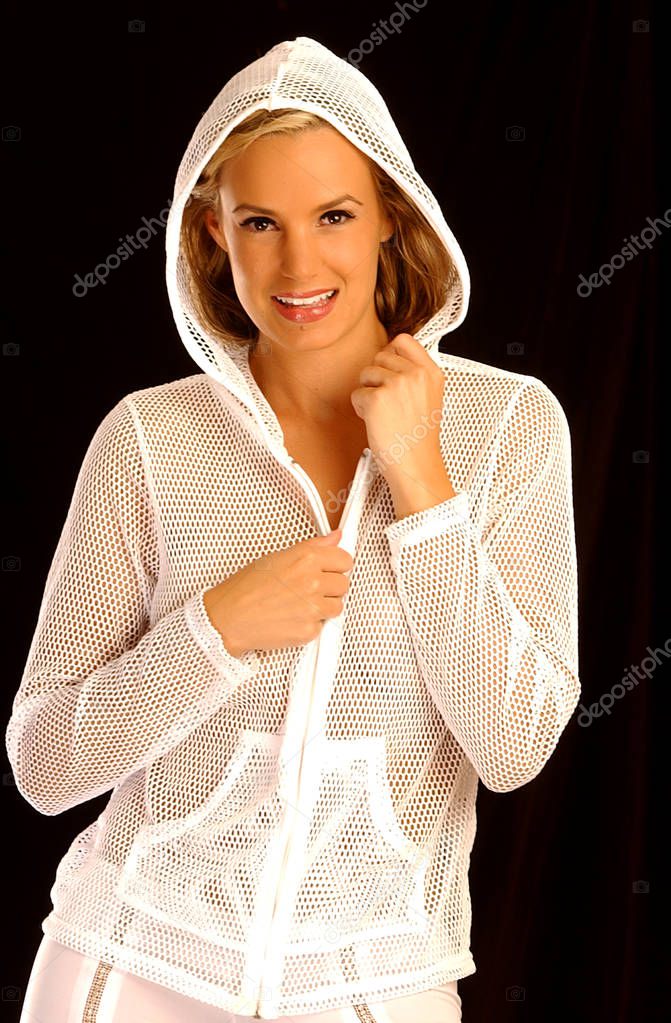 Sheer white mesh hood jacket with zipper - charming smile - white tight pants - clear eyes - smooth soft tan skin tones - shadow cleavage - alluring sensual invite flirting with sexual intention pose - isolated on copy space - rube red lipstick