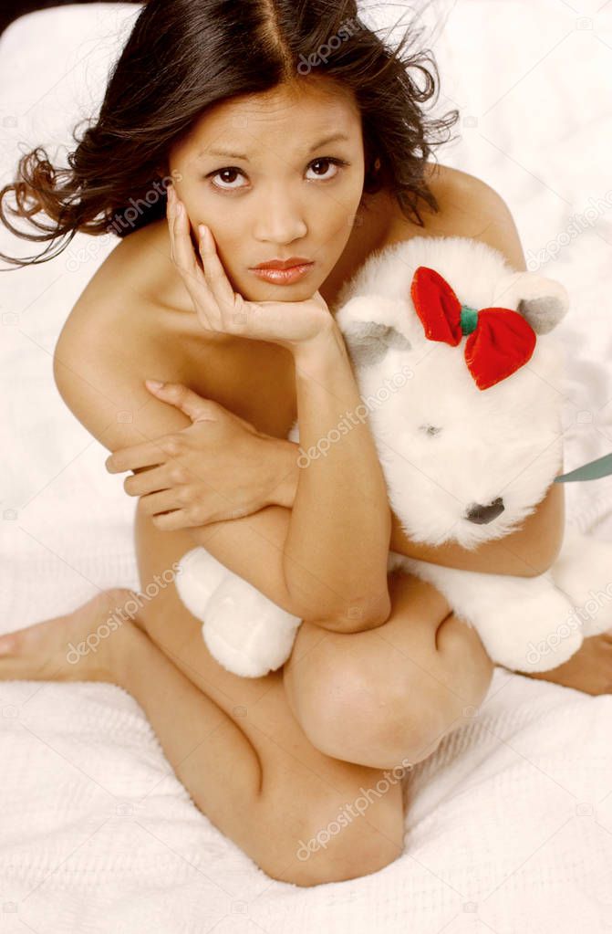 I love you valentine cute white teddy bear bare with little red bow - Natural Beauty model playfully poses topless and nude - dark short curly hair small breasts and nipples exposed black or white  background - simple clean makeup 
