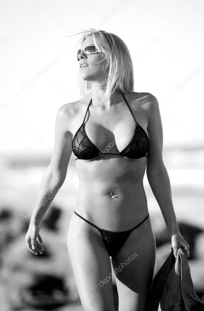 Monochromatic monochrome beach scene with blonde skimpy bikini model