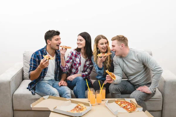 Neljä Ystävää Sohvalla Syövät Pizzaa Valkoisella Taustalla — kuvapankkivalokuva
