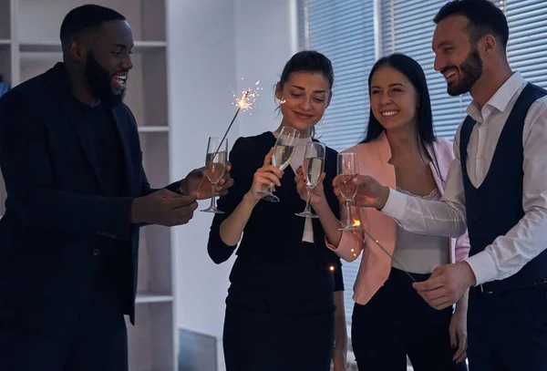 Happy Business People Drinking Champagne Holding Sparklers Royalty Free Stock Photos