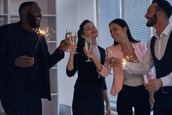 Happy Business People Drinking Champagne Holding Sparklers Royalty Free Stock Images
