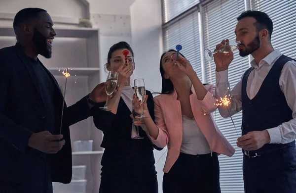 Happy Business People Drinking Champagne Holding Sparklers Stock Picture