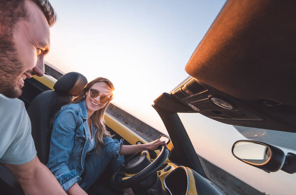 The man and woman traveling by car together