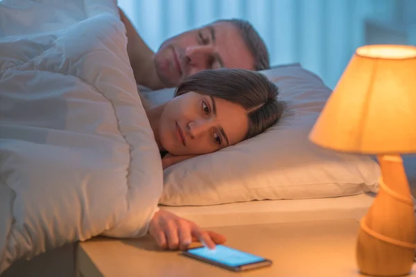 Woman Lay Bed Man Phone Evening Night Time — Stock Photo, Image