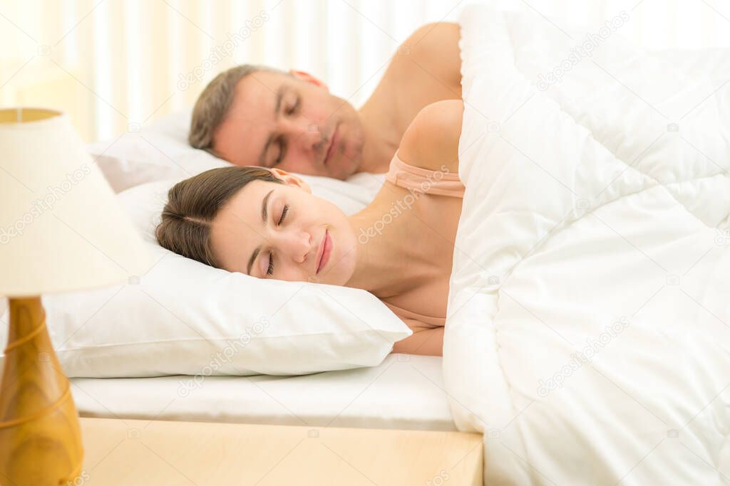 The beautiful couple sleeping on the bed