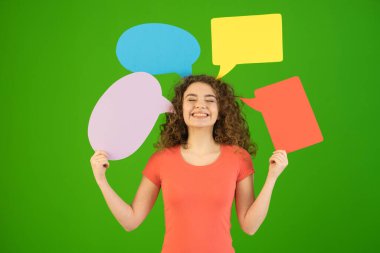 The happy woman hold a dialog signs on the green background