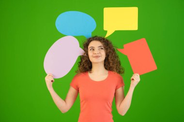 The happy woman hold a dialog signs on the green background