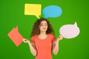The woman hold a dialog signs on the green background