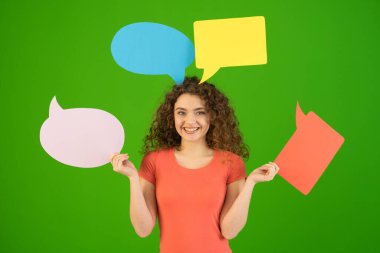 The smile woman with dialog signs on the green background