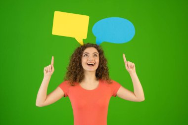 The woman gesture near a dialog signs on the green background