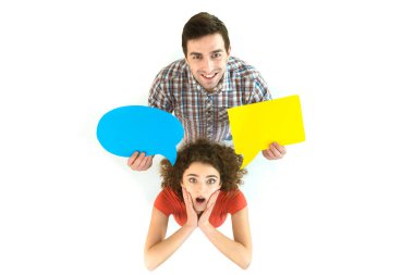 The couple stand near the dialog signs. View from above