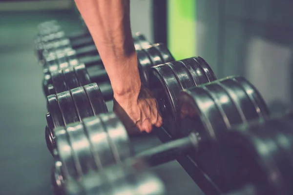 stock image The hand take a dumbbell in the gym